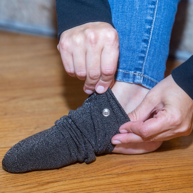  
                                    Pulling on the Earthing Grounded Sock for indoor grounding. (6640015900785) 
                                
                                